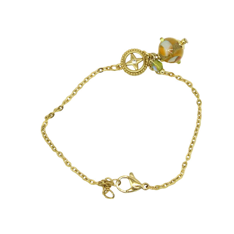 Bracelet Salvia en chaîne d'acier doré avec intercalaire en cristal et perle en verre de Murano topaz.