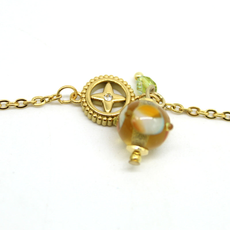 zoom Bracelet Salvia en chaîne d'acier doré avec intercalaire en cristal et perle en verre de Murano topaz.